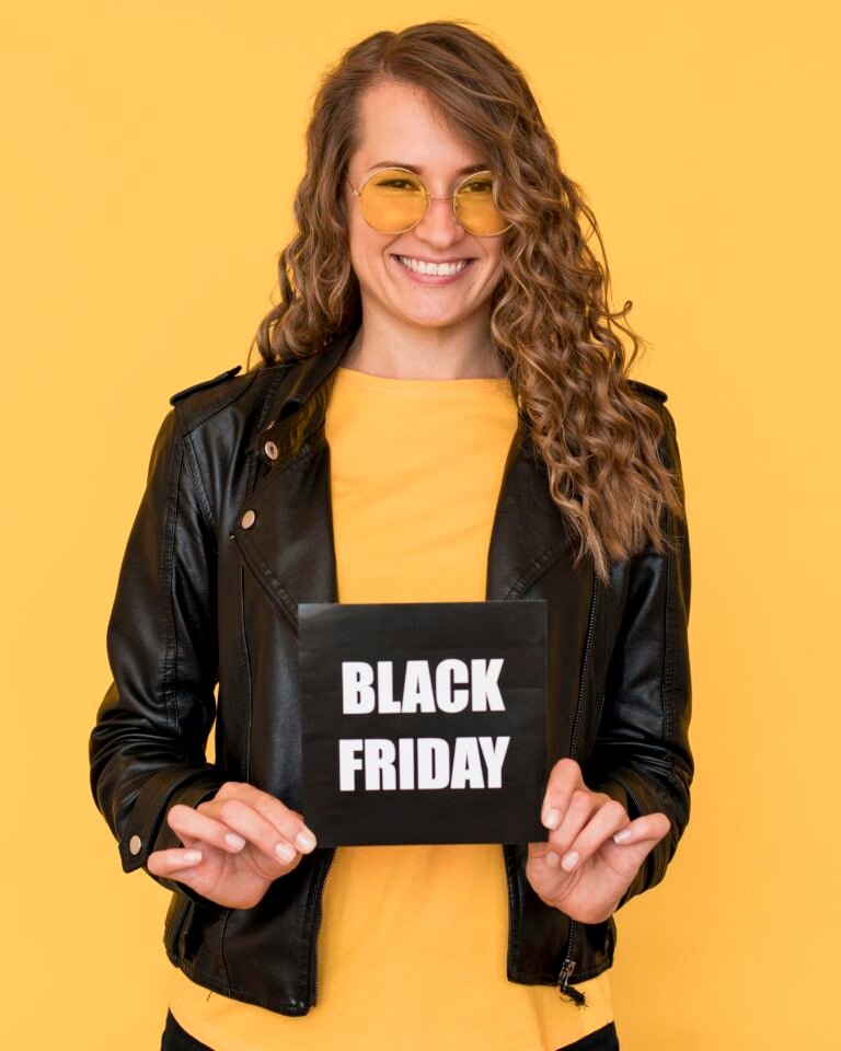 woman wearing glasses holding black friday label 1